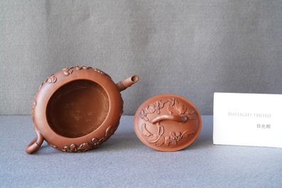 A Chinese Yixing stoneware teapot and cover with applied floral design, Kangxi