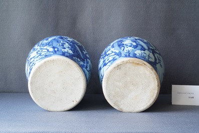 A pair of Chinese blue and white baluster vases and covers with birds in a rocky landscape, Kangxi