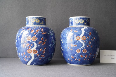 A pair of Chinese polychrome 'prunus on cracked ice' jars and covers, 19th C.