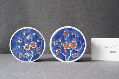 A pair of Chinese polychrome 'prunus on cracked ice' jars and covers, 19th C.