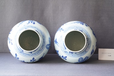 A pair of Chinese blue and white baluster vases and covers with birds in a rocky landscape, Kangxi