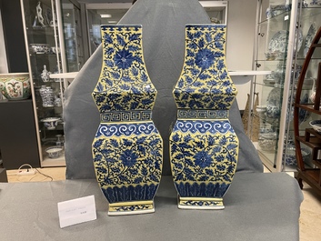 A pair of Chinese blue and white yellow-ground vases, 19th C.