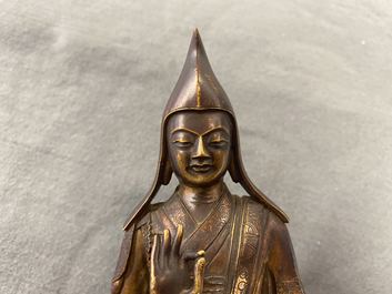 A Sino-Tibetan gilt bronze figure of a lama, 18/19th C.