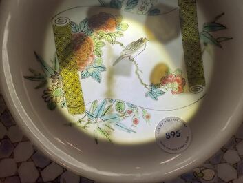 A Chinese famille rose 'ruby back' plate with a bird on a blossoming branch, Yongzheng