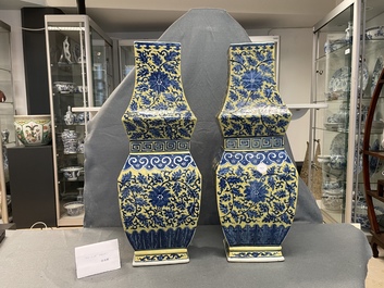 A pair of Chinese blue and white yellow-ground vases, 19th C.