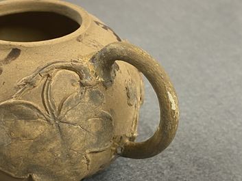 A bichrome Chinese Yixing stoneware teapot and cover with applied floral design, 19th C.