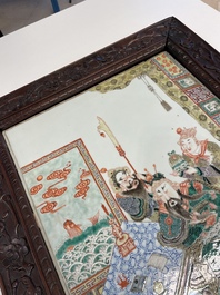 A large Chinese famille verte plaque in a sculpted wooden frame, 19th C.