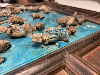 A Chinese square fahua 'Immortals' plaque mounted in a wooden table screen, Ming