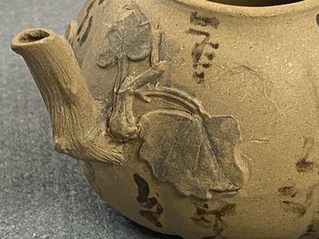 A bichrome Chinese Yixing stoneware teapot and cover with applied floral design, 19th C.