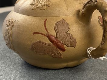 A bichrome Chinese Yixing stoneware teapot and cover with applied design, Kangxi