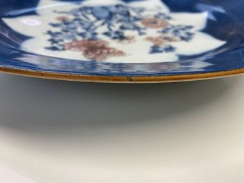 A Chinese blue, white and copper red powder blue-ground charger, Kangxi