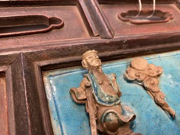 A Chinese square fahua 'Immortals' plaque mounted in a wooden table screen, Ming