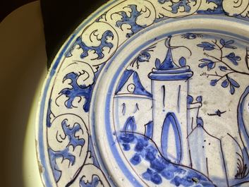 A blue, white and manganese Portuguese faience charger with a castle, 17th C.
