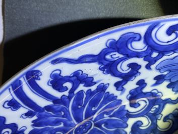 A pair of Chinese blue and white 'lotus scroll' chargers, Kangxi