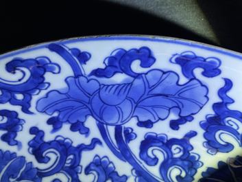 A pair of Chinese blue and white 'lotus scroll' chargers, Kangxi