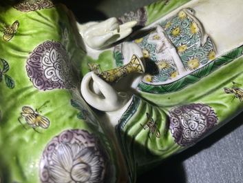 A Chinese verte biscuit group of Guanyin on a lotus throne, Kangxi