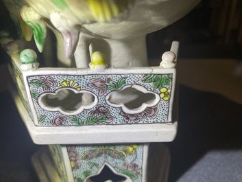 A Chinese verte biscuit group of Guanyin on a lotus throne, Kangxi