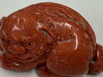 A Chinese carved red coral model of a Buddhist lion, 19/20th C.