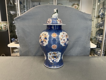A Chinese blue, white, iron red and gilt powder blue-ground vase and cover, Kangxi