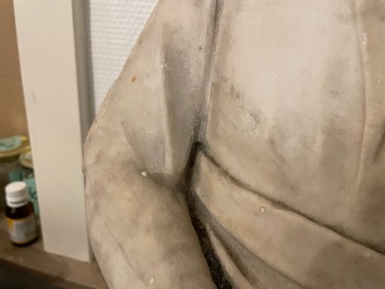 A Roman marble statue of a philosopher holding a parchment roll, ca. 2nd C.
