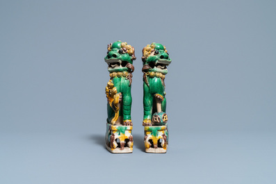 A pair of Chinese sancai-glazed biscuit Buddhist lion joss stick holders, Kangxi