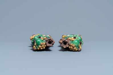 A pair of Chinese sancai-glazed biscuit Buddhist lion joss stick holders, Kangxi