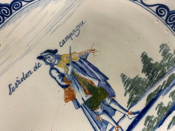 A polychrome Dutch Delft charger with a violinist, 1st half 18th C.