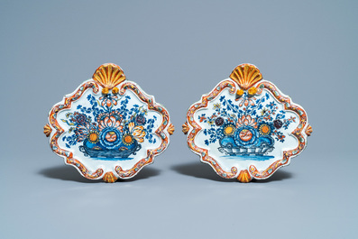 A pair of polychrome Dutch Delft 'flower basket' plaques, 18th C.