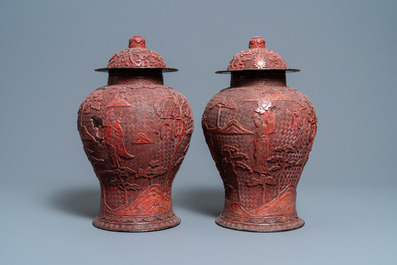 A pair of Chinese red cinnabar lacquer vases and covers, Zhengde mark, Qing