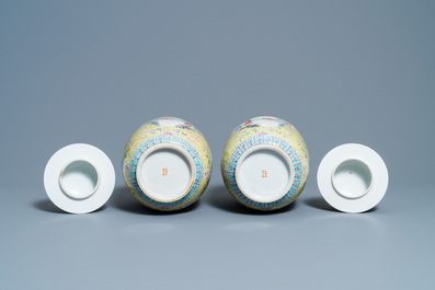 A pair of Chinese famille rose yellow-ground vases and covers, Guangxu mark, Republic