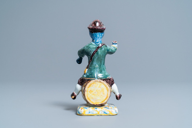 A polychrome Dutch Delft figure of a wine drinker on a barrel inscribed 'Rood Wyn', 18th C.