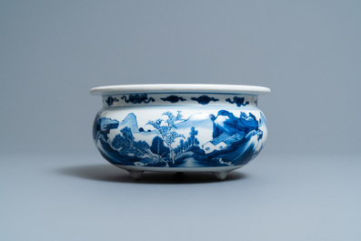 A Chinese blue and white tripod censer with figures in a mountainous river landscape, Kangxi