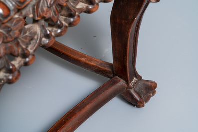 A Chinese carved wooden stand with marble top, 19th C.
