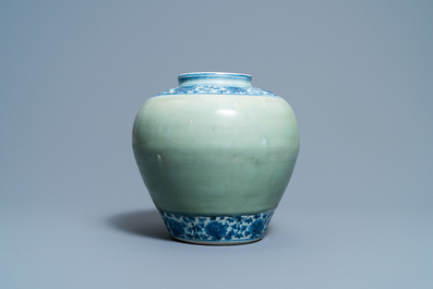 A Chinese celadon-ground and blue and white 'lotus scroll' jar, Ming