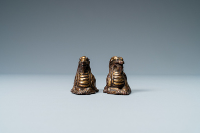 Two Chinese gilt and lacquered bronze 'mythical beast' scroll weights, late Ming