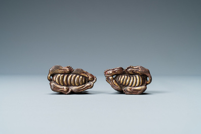 Two Chinese gilt and lacquered bronze 'mythical beast' scroll weights, late Ming