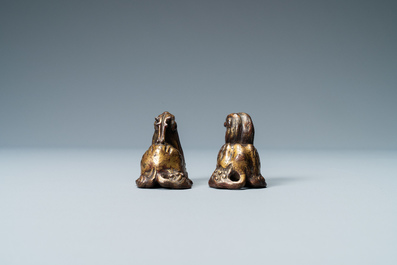 Two Chinese gilt and lacquered bronze 'mythical beast' scroll weights, late Ming