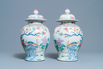 A pair of Chinese famille rose 'pheasants' vases and covers, 19th C.