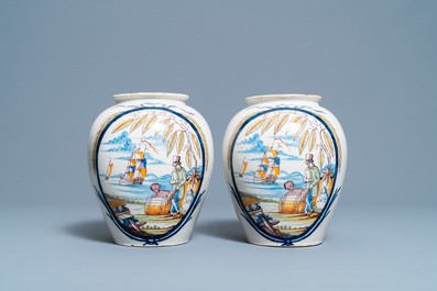 A pair of polychrome Dutch Delft tobacco jars with a merchant and a slave, late 18th C.