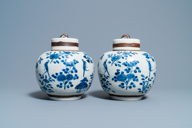 A pair of Chinese blue and white Nanking crackle-glazed jars and covers, 19th C.