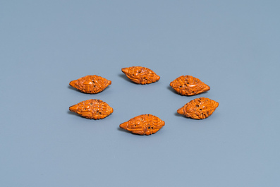 Six Chinese carved fruit pits, a walnut snuff bottle and a gourd cricket box, 19/20th C.