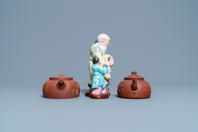 Two Chinese Yixing stoneware teapots and a famille rose 'Shou Lao' group, Kangxi and 20th C.