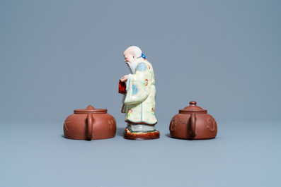 Two Chinese Yixing stoneware teapots and a famille rose 'Shou Lao' group, Kangxi and 20th C.