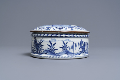 A round Dutch Delft blue and white box and cover with tobacco harvesting scenes, 18th C.