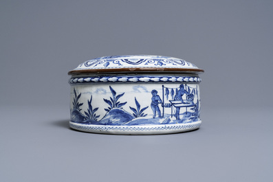 A round Dutch Delft blue and white box and cover with tobacco harvesting scenes, 18th C.