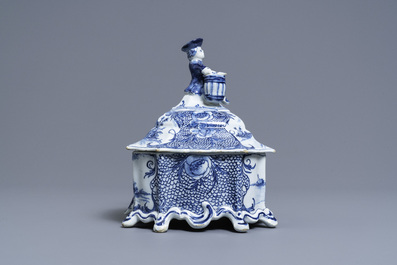 A Dutch Delft blue and white tobacco box and cover with a boy near a barrel, 18th C.