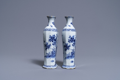 A pair of Dutch Delft blue and white vases and a 'peacock's tail' plate, 18th C.