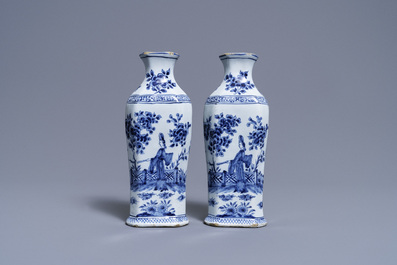 A pair of Dutch Delft blue and white vases and a 'peacock's tail' plate, 18th C.