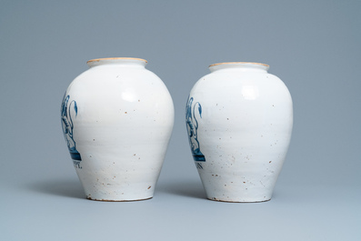 A pair of large Dutch Delft blue and white tobacco jars with the arms of Amsterdam, 18th C.