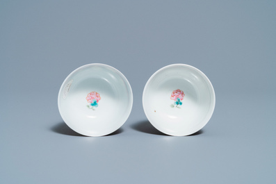 A pair of Chinese famille rose ruby-ground cups and saucers, Yongzheng